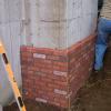 New chimney going up (starting with a full brick facade to cover the large concrete foundation)